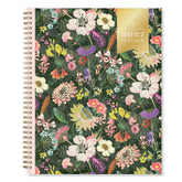 A spiral-bound 2027 floral planner shown closed, featuring a dense multicolor wildflower pattern on a dark green background with a gold &