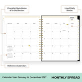 An open spiral-bound monthly planner spread showing a calendar year layout with labeled callouts for checklist style notes and to-do sections, lined daily blocks, and reference calendars. The bottom text reads &