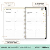 An open spiral-bound weekly planner spread on a white background with callout labels pointing to sections for weekly goals, to-do checklists, daily lined sections, and a January 2027 calendar page. The bottom banner reads &