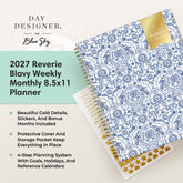 Day Designer for Blue Sky 2027 Reverie Blavy Weekly Monthly 8.5x11 Planner shown at an angle with a blue and white ornate pattern cover, gold foil details,  and sticker sheet