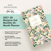 Day Designer for Blue Sky 2027-28 Marjorie 3x6 Monthly 24-Month Planner shown at an angle on a light beige background with a mint green text panel. The planner cover features a floral pattern with green leaves, peach and cream flowers, and purple blossoms, with a gold foil label on the front.