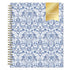 A 2027 spiral-bound weekly monthly planner with a white cover decorated in a blue floral and ornamental pattern, featuring a gold foil seal on the top right that reads &