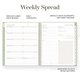 An open spiral-bound weekly planner spread on a white background with callout lines and text describing features such as spaced lined daily blocks, daily checklists, weekly check-in prompts, and dedicated to-do and notes sections.