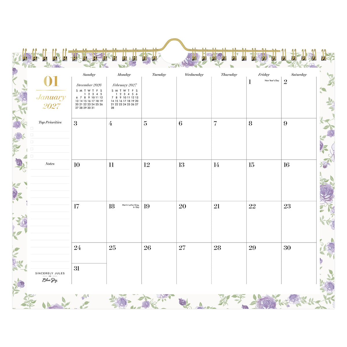 A spiral-bound monthly calendar page for January 2027, featuring a white background with light purple floral borders and gold accents, including a gold spiral binding and a gold clip at the top.