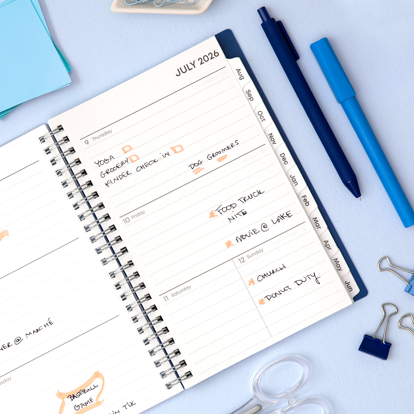 Blue spiral-bound agenda with &
