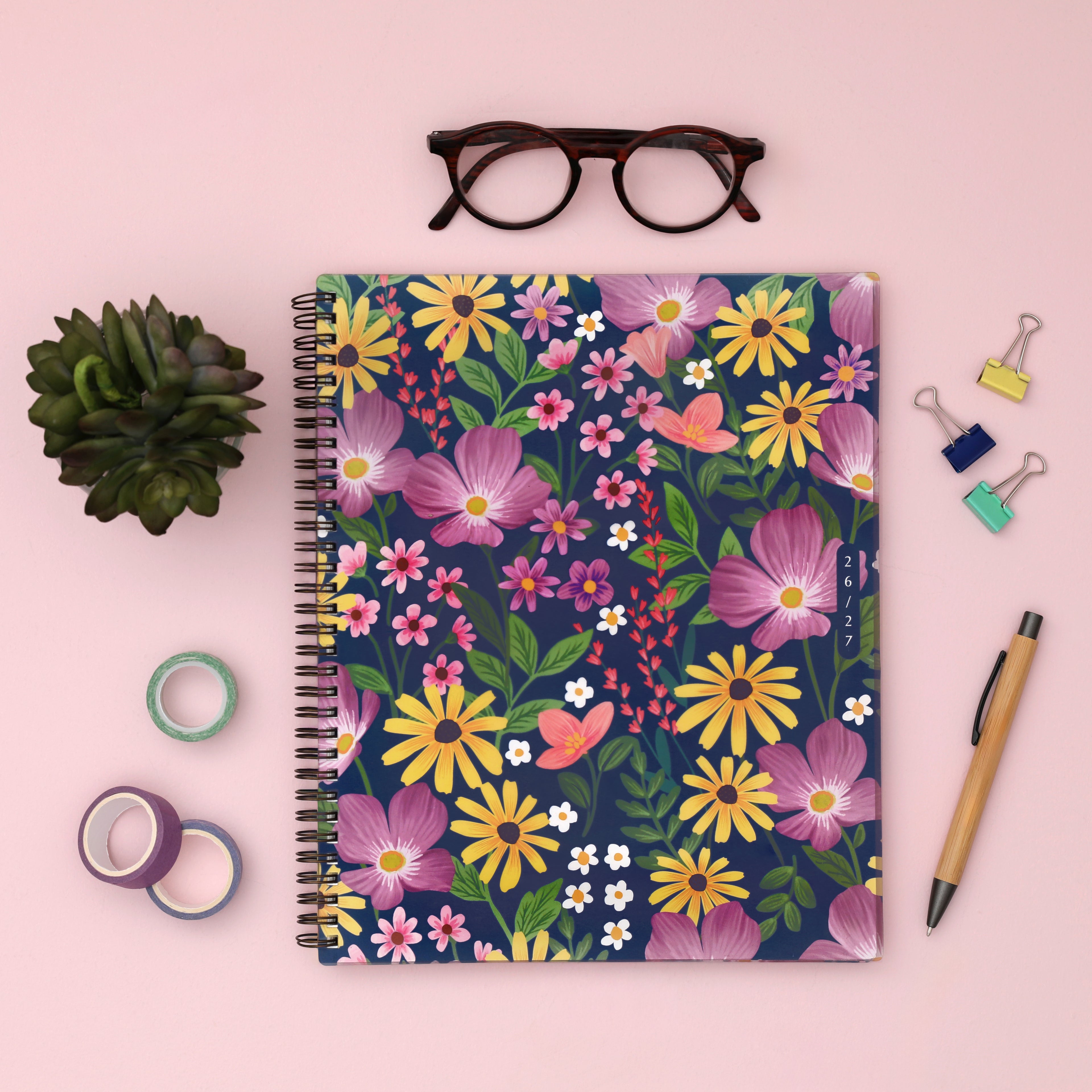 Floral front cover with pink, yellow, and purple flowers on a blue background