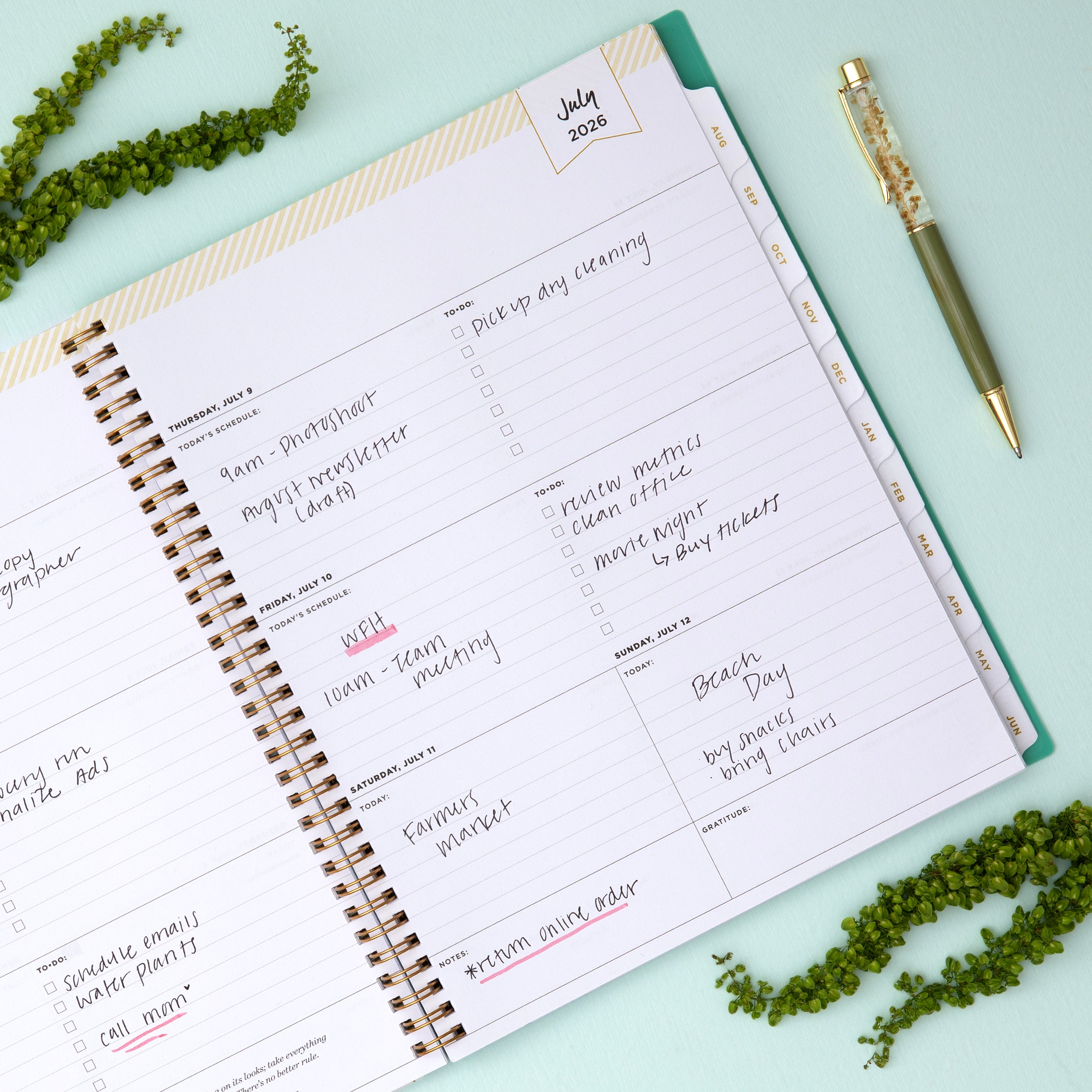 Planner with green palm leaf pattern on a white background in 8.5x11 planner size this july 2026 - june 2027 planner features a monthly spread with ample writing space for each day, monthly reference calendar, sections for note taking, bullet points, and check lists.
