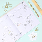 this july 2026 - june 2027 planner features a monthly spread with ample writing space for each day, monthly reference calendar, sections for note taking, bullet points, and check lists.
