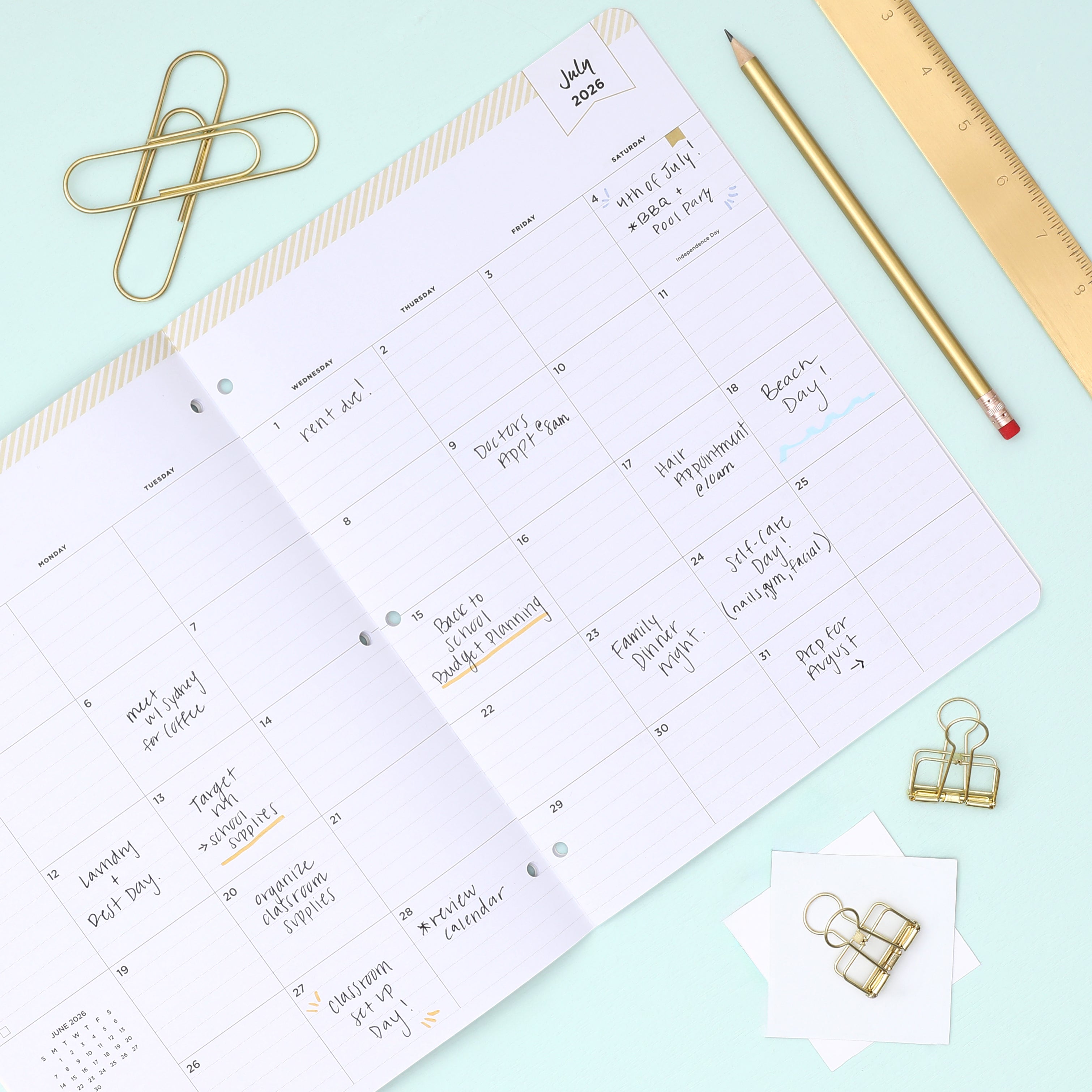 this july 2026 - june 2027 planner features a monthly spread with ample writing space for each day, monthly reference calendar, sections for note taking, bullet points, and check lists.
