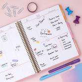 this july 2026 - june 2027 planner features a monthly spread with ample writing space for each day, monthly reference calendar, sections for note taking, bullet points, and check lists.
