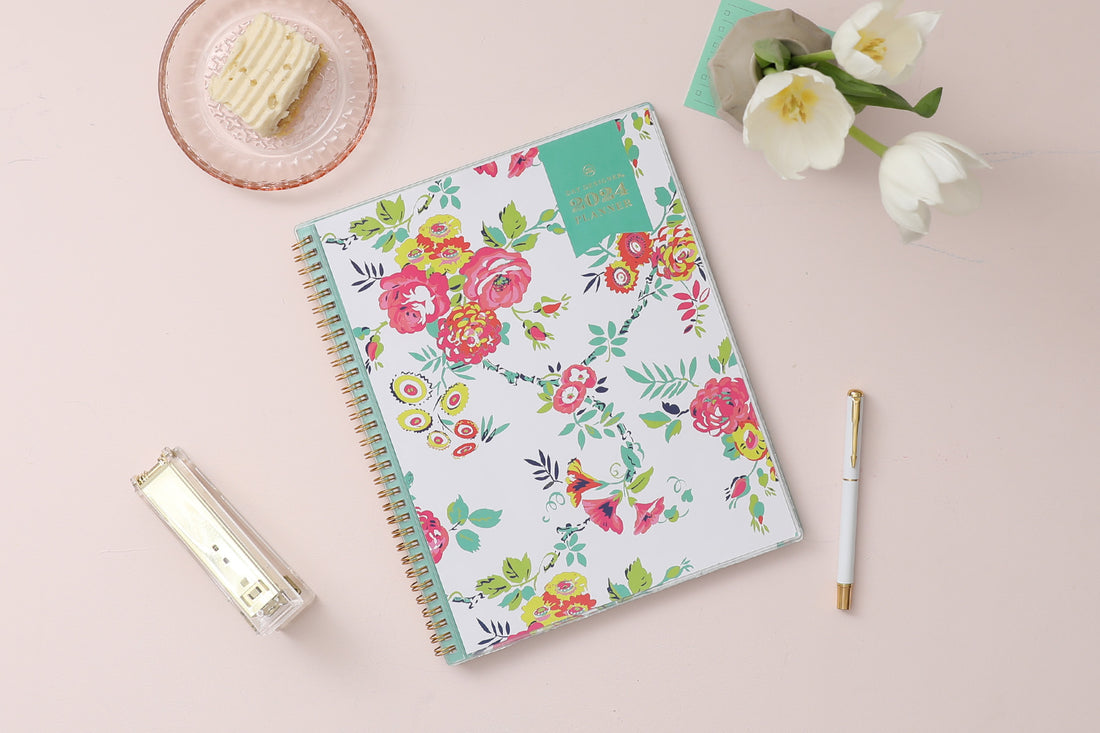 This January 2024 to December 2024 weekly monthly 5x8 planner featuring yellow and pink floral front cover pattern and gold twin wire-o binding