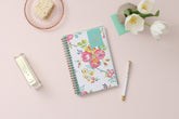 This January 2024 to December 2024 weekly monthly 5x8 planner featuring yellow and pink floral front cover pattern and gold twin wire-o binding