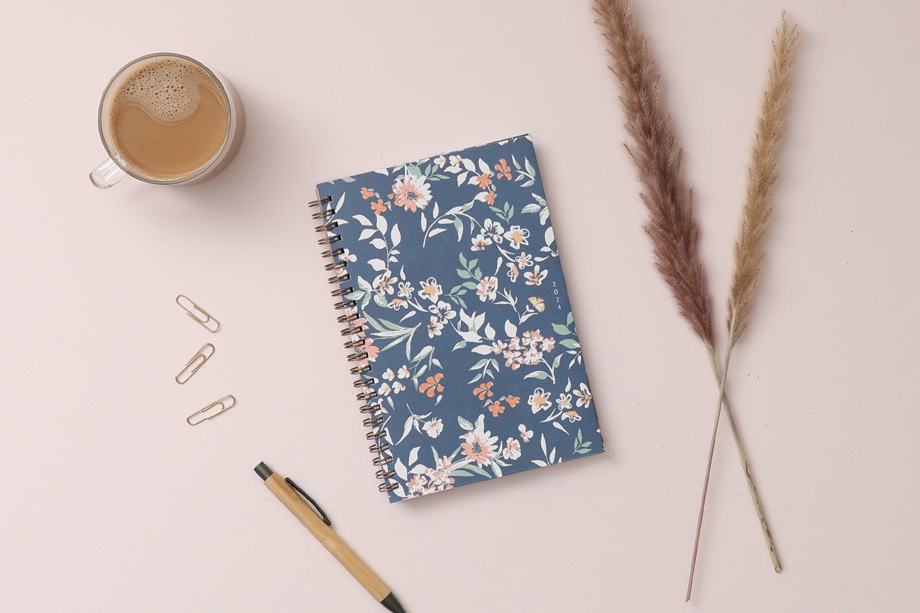 in partnership with one tree planted, the 2024 weekly monthly planner features a cute floral pattern and navy background cover.