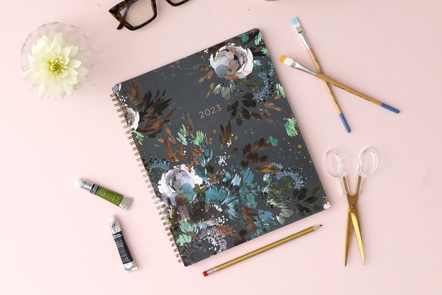 The kelly ventura 2024 weekly monthly planner for blue sky features beautiful watercolored floral cover with gold twin wire-o binding in a 8.5x11 planner size.