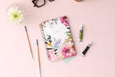 The kelly ventura 2024 weekly monthly planner for blue sky features beautiful watercolored floral cover with gold twin wire-o binding in a 5x8 planner size.