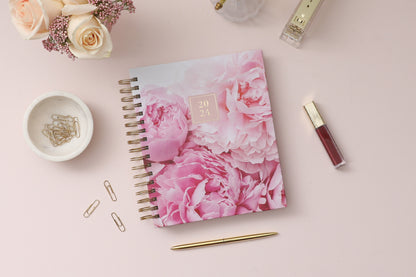 2024 Rachel Parcell daily planner featuring a beautiful rose pattern hardcover on gold twin wire-o binding in a 7x9 size.