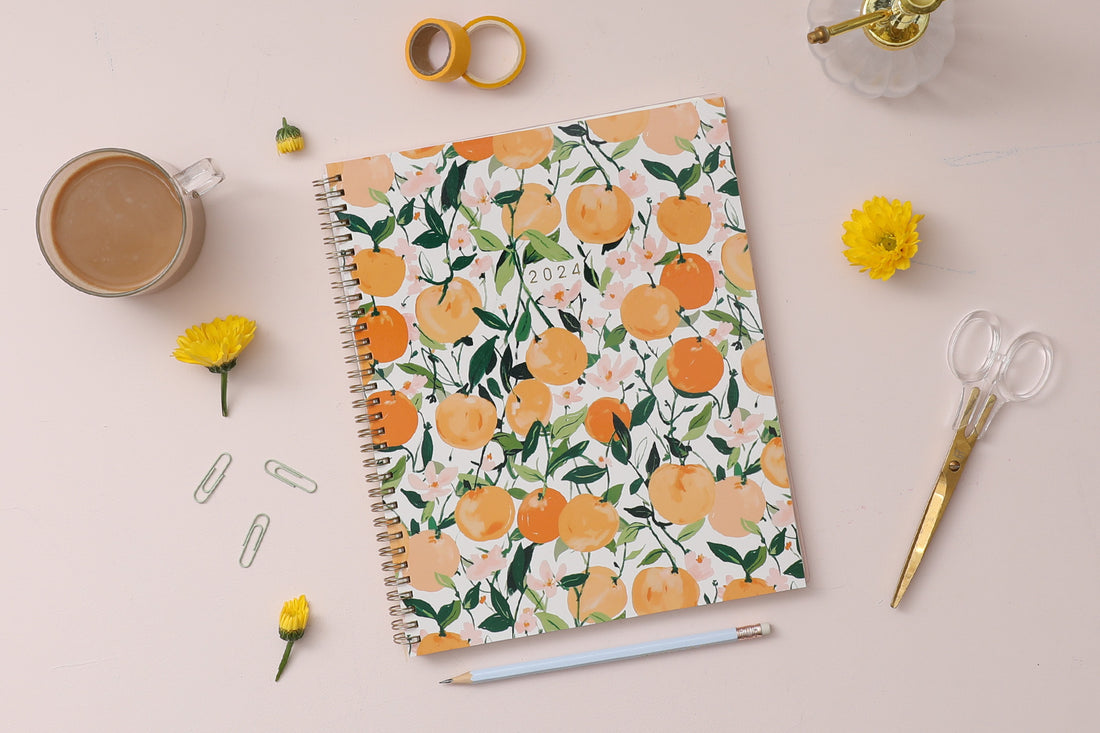 January 2024 - December 2024 weekly monthly planner featuring oranges and cuties on 8.5x11 planner size gold wire-o binding