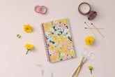 2024 planner weekly monthly featuring gold wire-o and yellow pink flowers