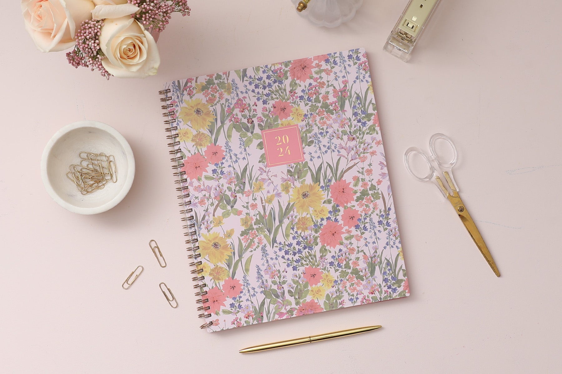 January 2024 - December 2024 8.5x11 planner size featuring gold wire-o binding