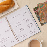 Open planner spread with lined writing space, white monthly tabs in 8.5x11 size