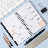 monthly layout featuring lined writing space, reference calendars, lined writing space and monthly tabs on this pocket sized planner