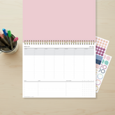 12 x 9 weekly planning pad featuring a navy front cover with twin wire-o, interior layout featuring weekly view Sunday - Saturday with bullet points, lined writing space, goals, notes section, and habit tracker