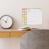 April 2026 calendar with floral design on a white background and checkered daisies 