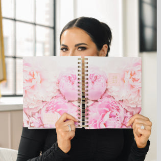 Rachel Parcell holding a 2023 Peony Planner from her Blue Sky collection