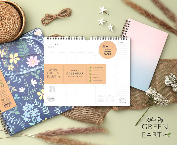 Blue Sky Green Earth planners and calendar on top of a flat-lay scene with floral