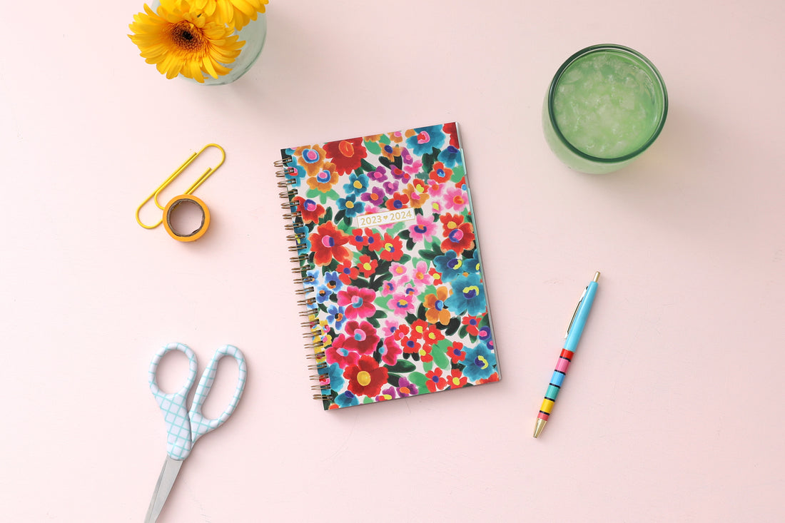 assorted colorful flowers front cover, gold twin wire o binding, dated 2023-2024 5x8 planner size