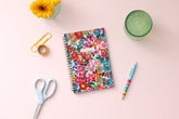 assorted colorful flowers front cover, gold twin wire o binding, dated 2023-2024 5x8 planner size