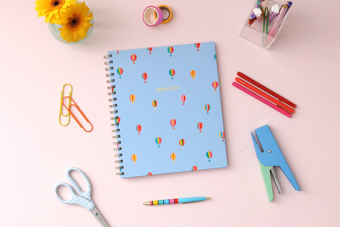 Color Me Courtney designed for Blue Sky featuring air balloons on a blue sky background and gold wire-o binding 8x10 academic planner